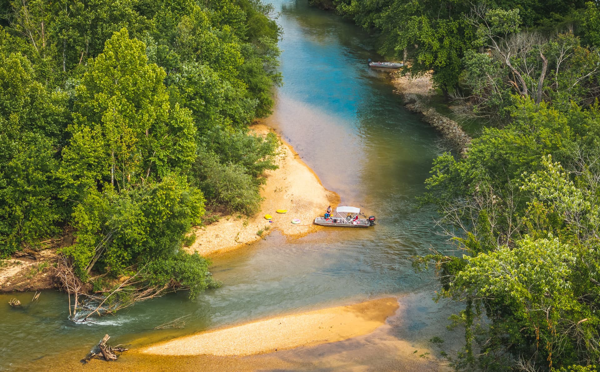 Boats pulled up on a gravel bar on the Current River